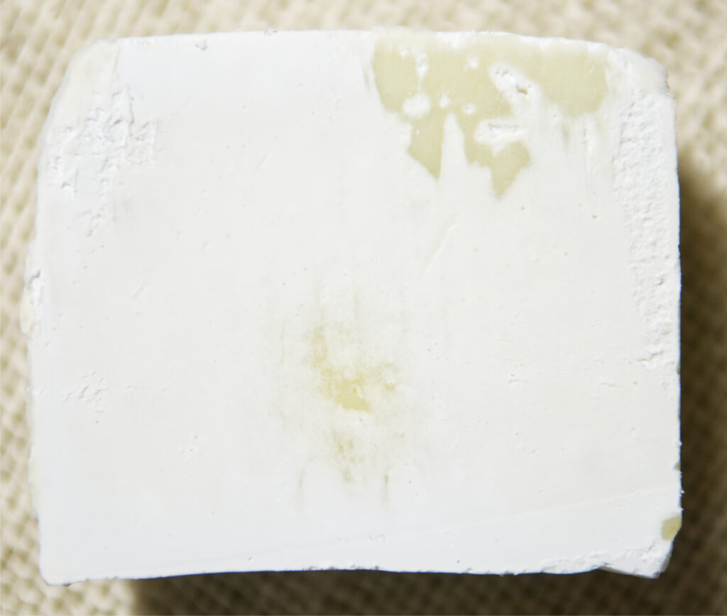A layer of soda ash on soap