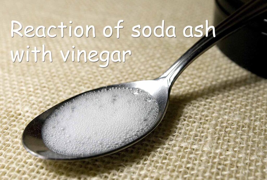 Reaction between vinegar and soda ash producing bubbles
